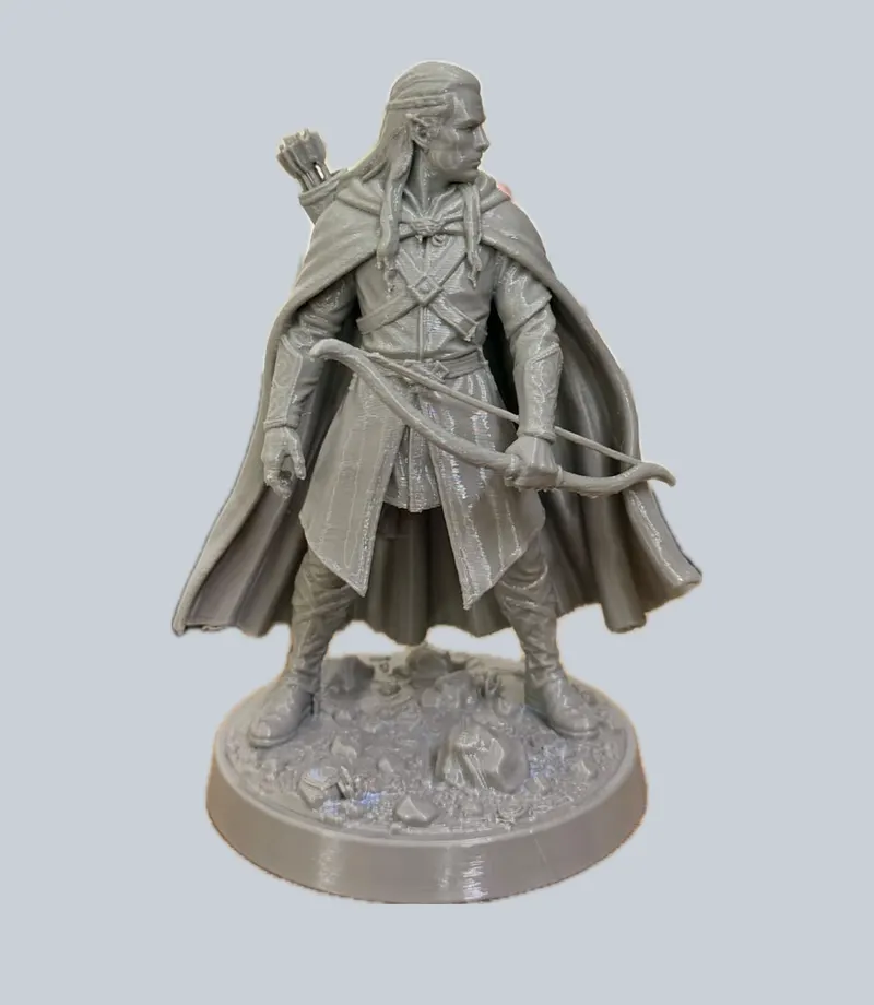 Grey figurine of an elven archer holding a bow